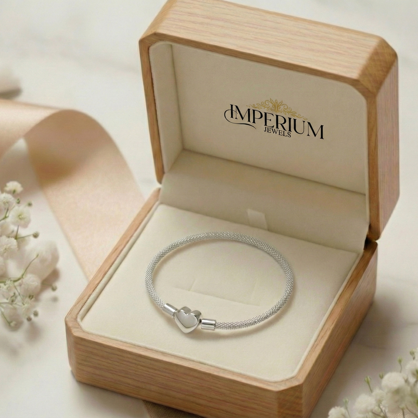 Silver bracelet in an open wooden box with 'Imperium Jewels' branding.