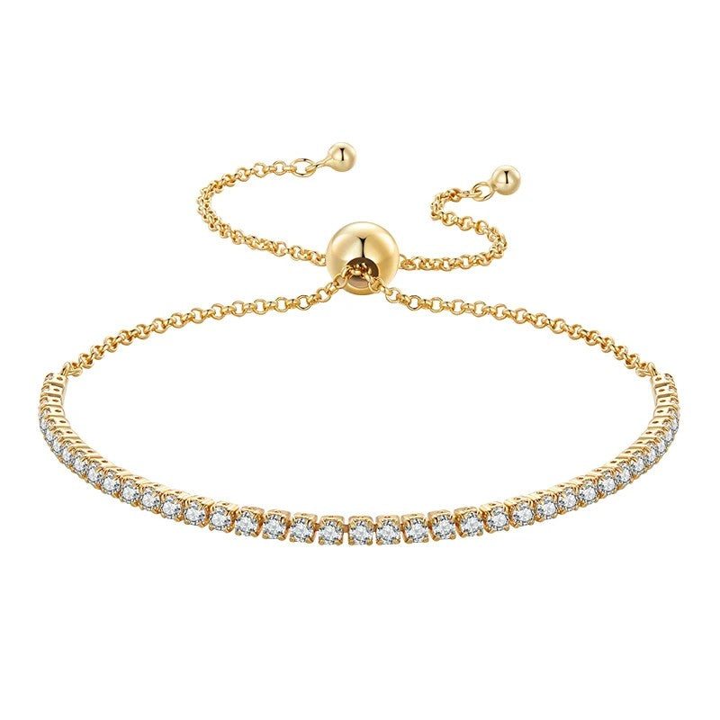 Gold bracelet with diamond accents on a white background