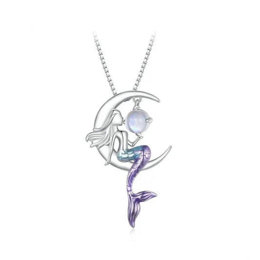 Mermaid on a moon pendant with a heart-shaped opal stone on a white background