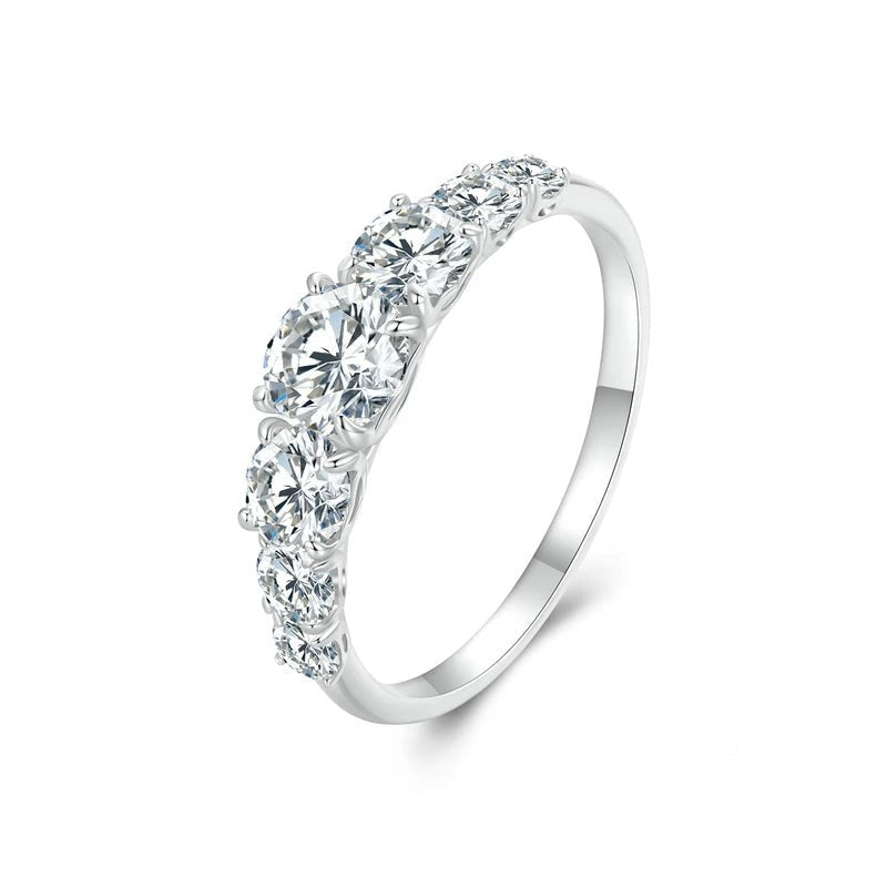 Silver ring with clear gemstones on a white background