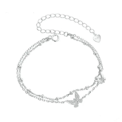 Silver bracelet with butterfly charms on a white background