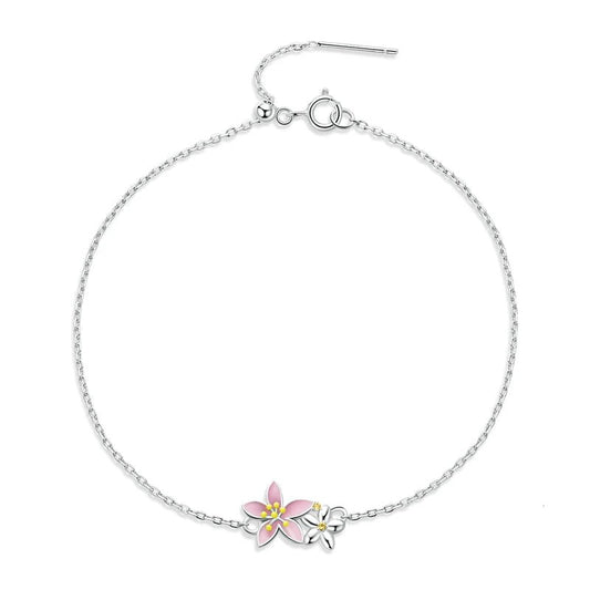 Silver bracelet with a pink flower charm on a white background