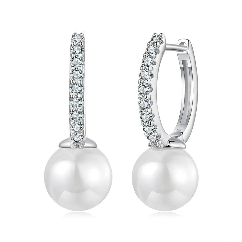 Pearl earrings with diamond accents on a white background