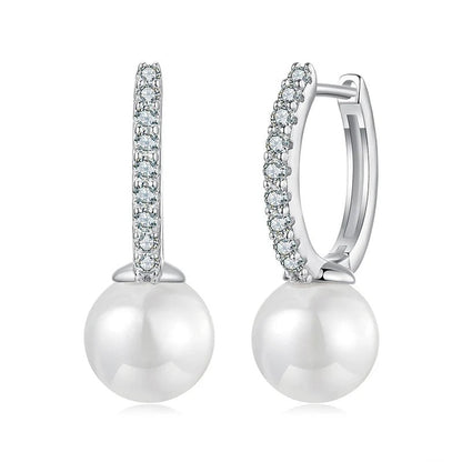 Pearl earrings with diamond accents on a white background
