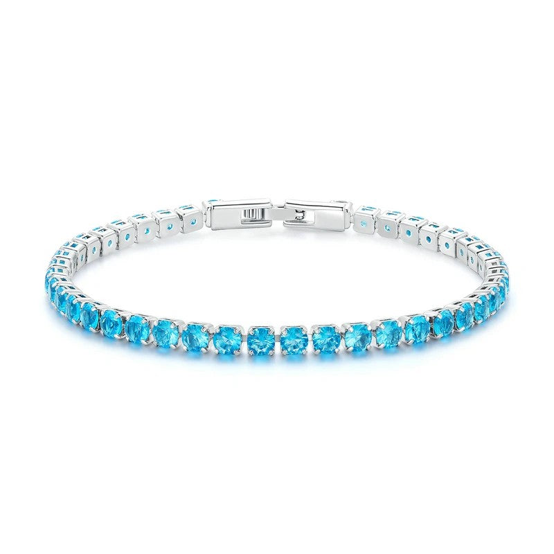 Silver bracelet with blue gemstones on a white background