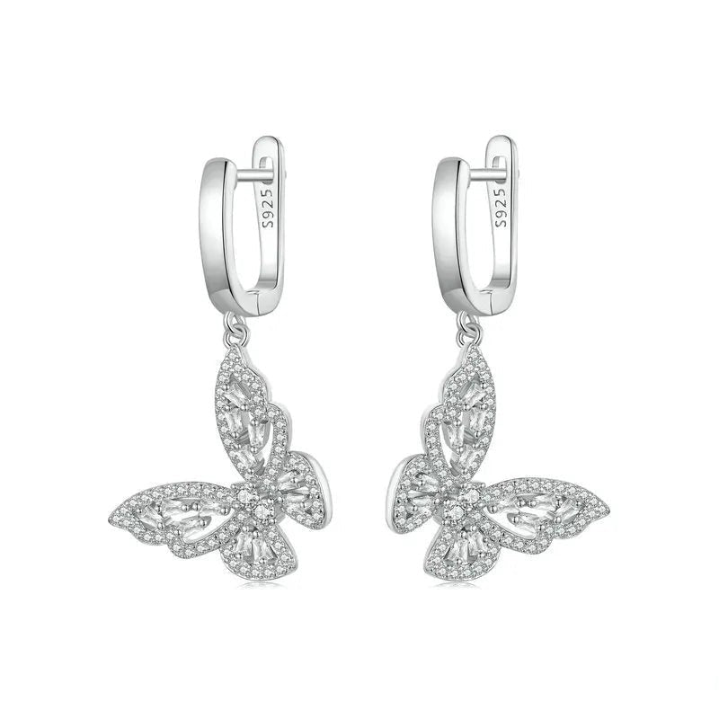 Butterfly-shaped silver earrings on a white background