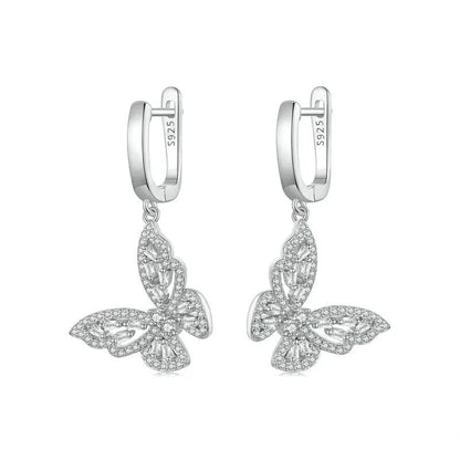 Butterfly-shaped silver earrings on a white background
