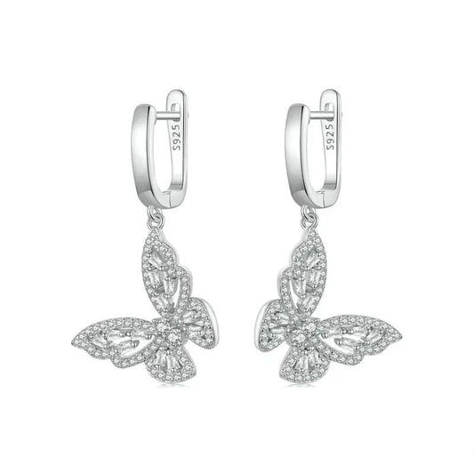Butterfly-shaped silver earrings on a white background