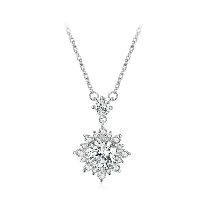 Silver necklace with a snowflake-shaped pendant on a white background