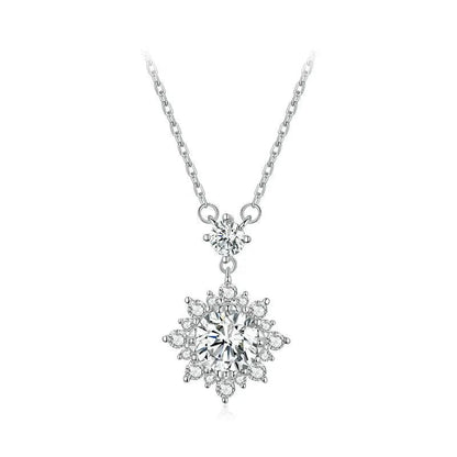 Silver necklace with a snowflake-shaped pendant on a white background