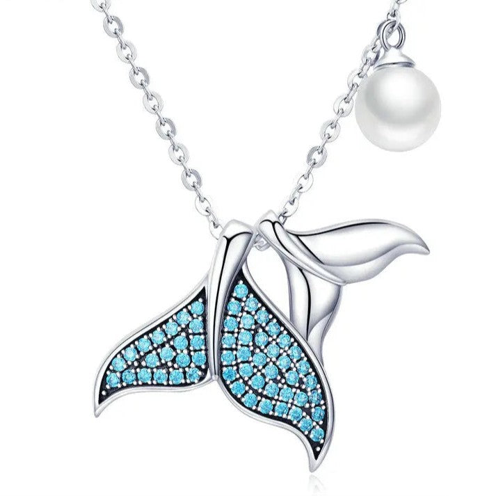 Mermaid tail necklace with blue gemstones and a pearl on a white background