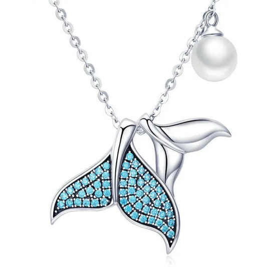 Mermaid tail necklace with blue gemstones and a pearl on a white background