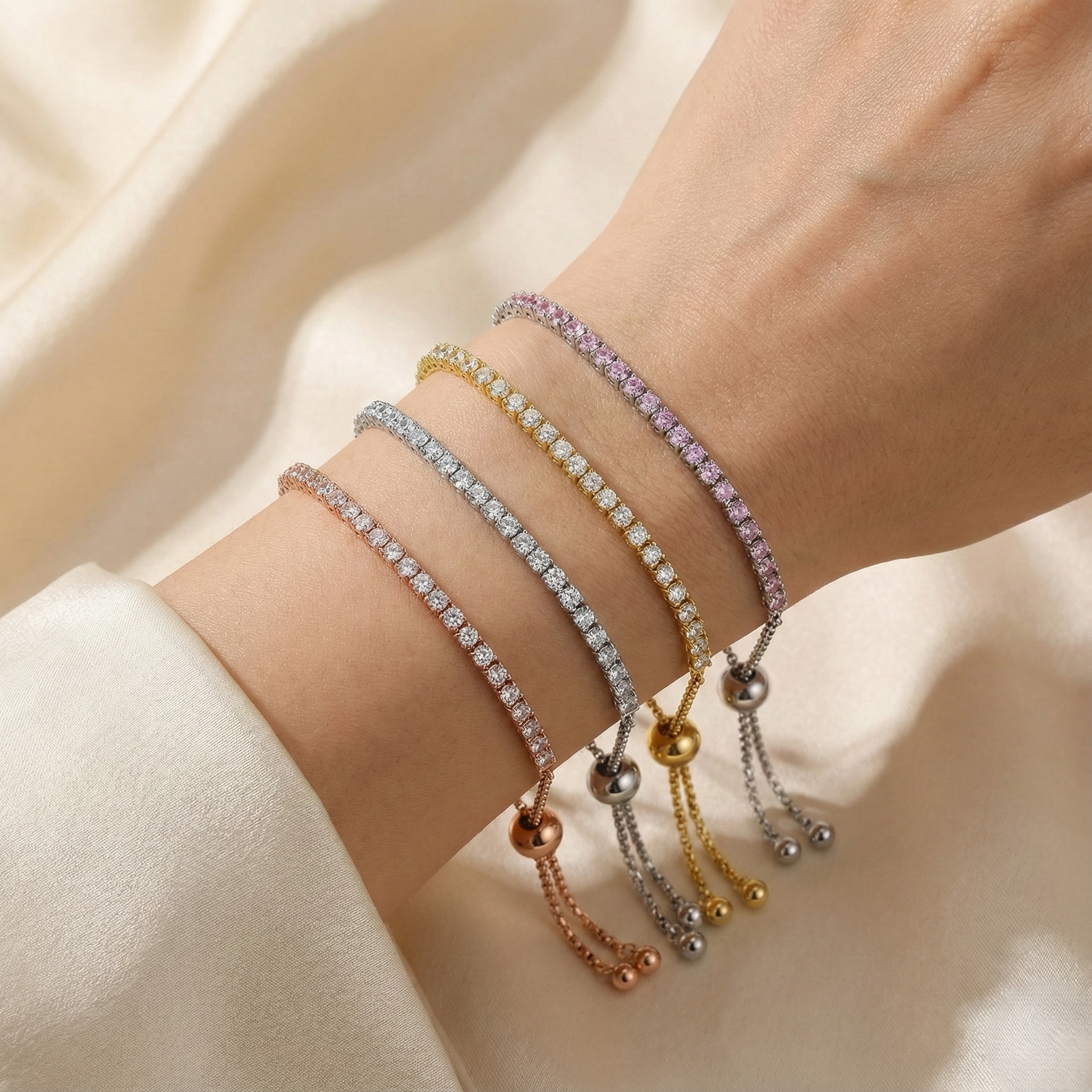 Multiple colorful bracelets on a wrist against a neutral background