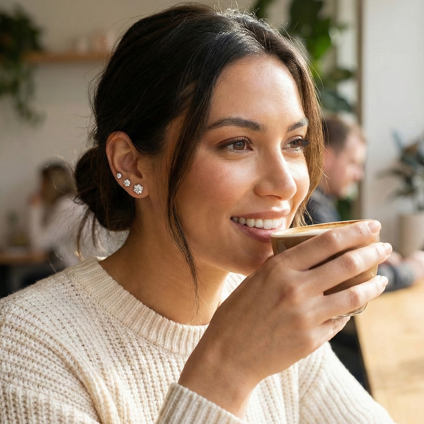Woman smiling and holding a cup in a casual setting