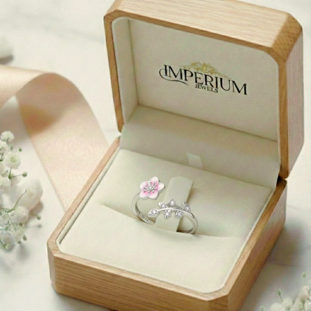 Silver ring with a pink flower design in an open jewelry box labeled 'Imperium Jewels'.