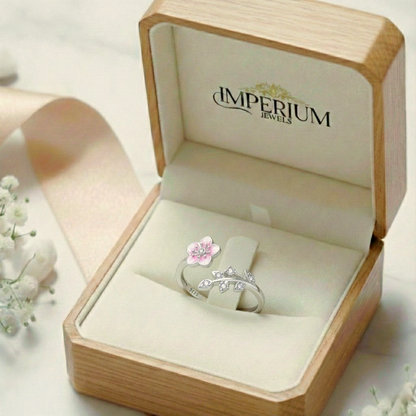 Silver ring with a pink flower design in an open jewelry box labeled 'Imperium Jewels'.