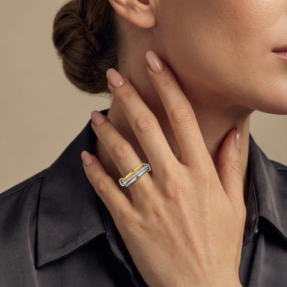 Close-up of a woman's hand wearing a ring with a neutral background