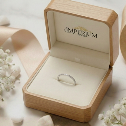 Diamond ring in a wooden box with 'Imperium Jewels' branding, surrounded by delicate flowers.