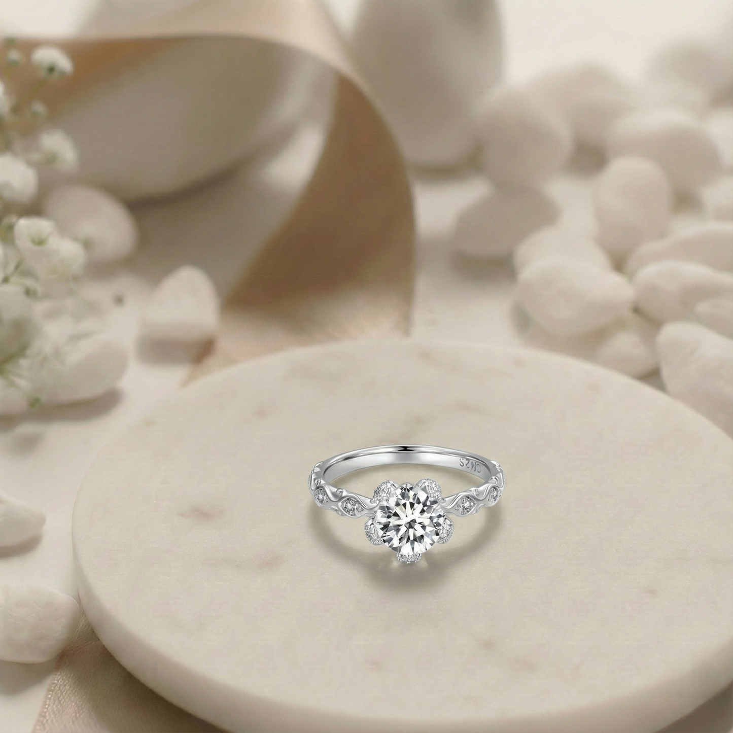 Silver ring with a diamond on a stone surface with flowers in the background