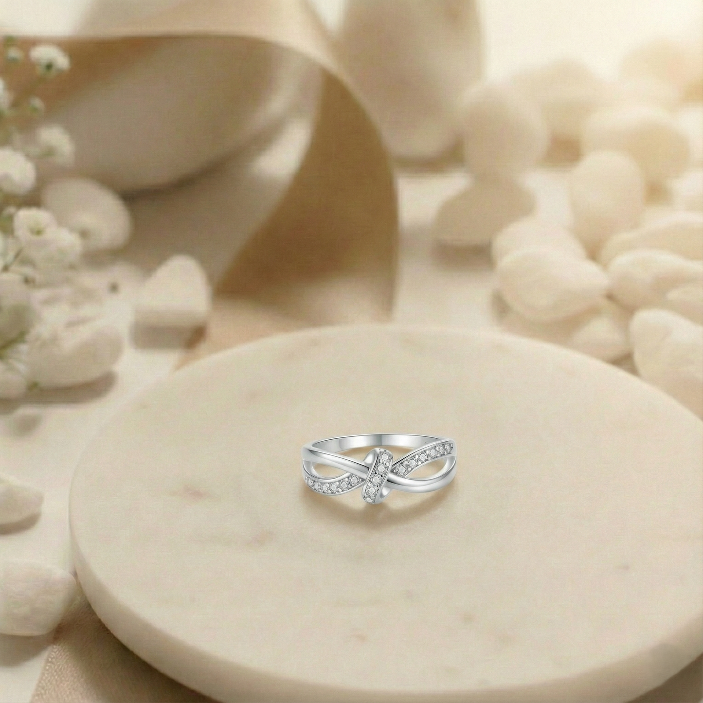 Silver ring on a beige stone with a soft background
