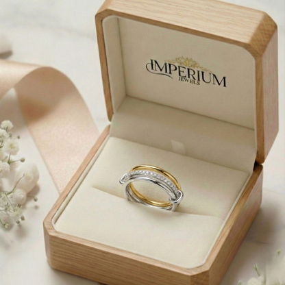 Two gold rings in a wooden box with 'Imperium Jewels' branding.