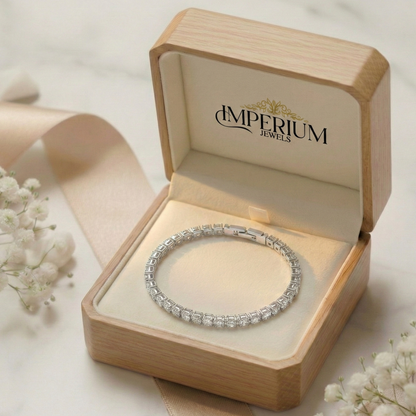 Silver bracelet in an open 'Imperium Jewels' box with white flowers in the background