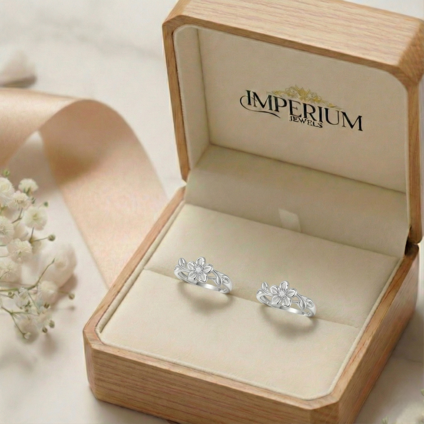 Silver earrings in a wooden box with 'Imperium Jewels' branding.
