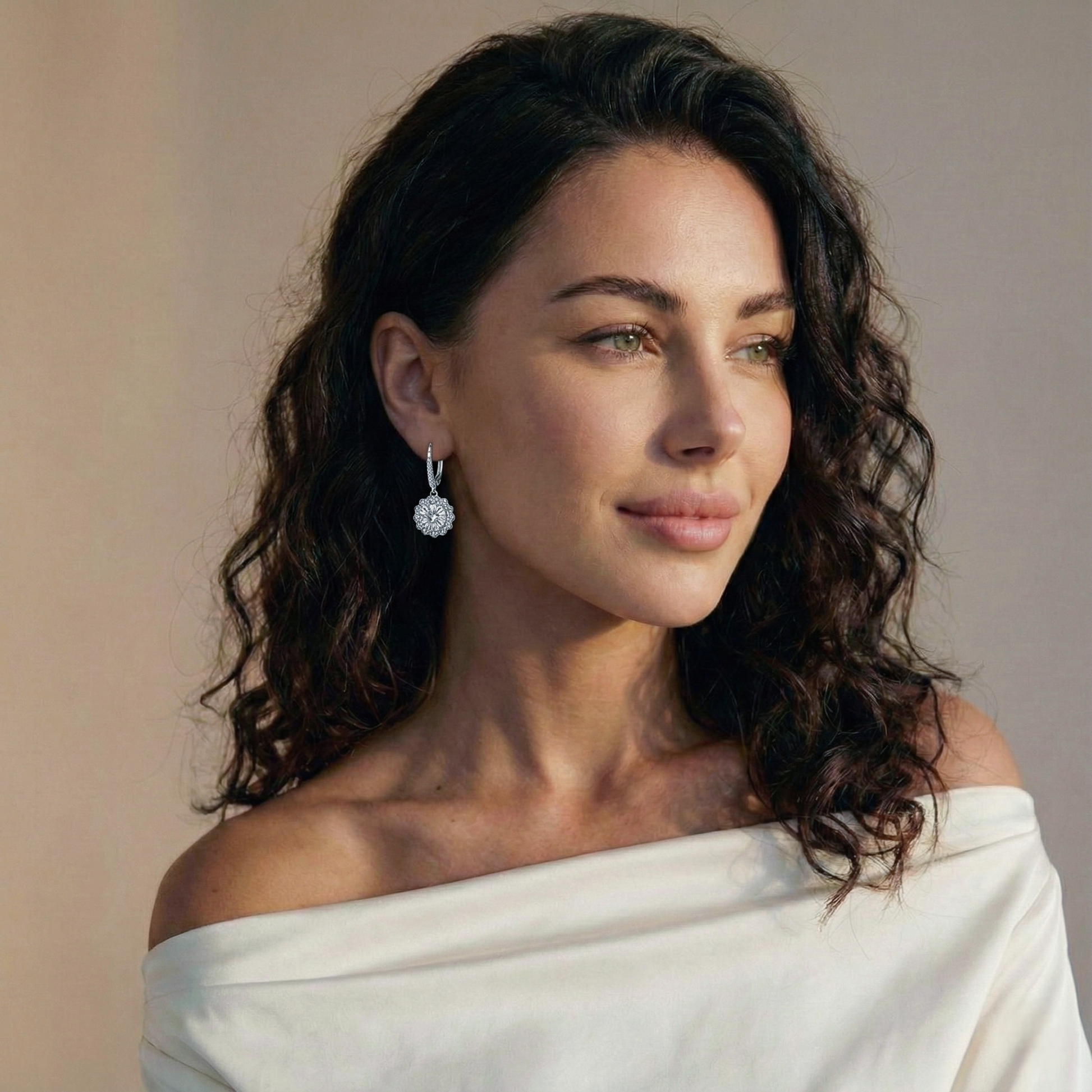 Woman wearing a white off-shoulder top with a neutral background