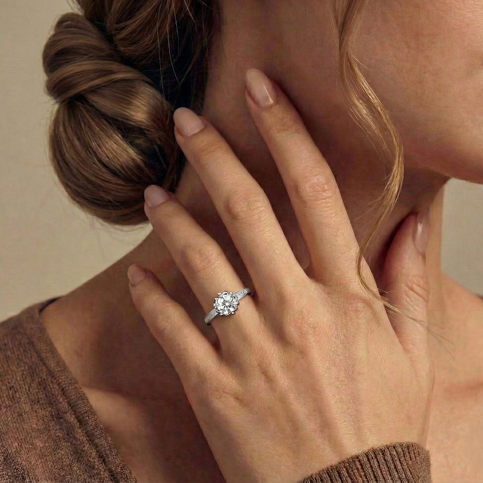 Close-up of a hand wearing an engagement ring with a blurred background