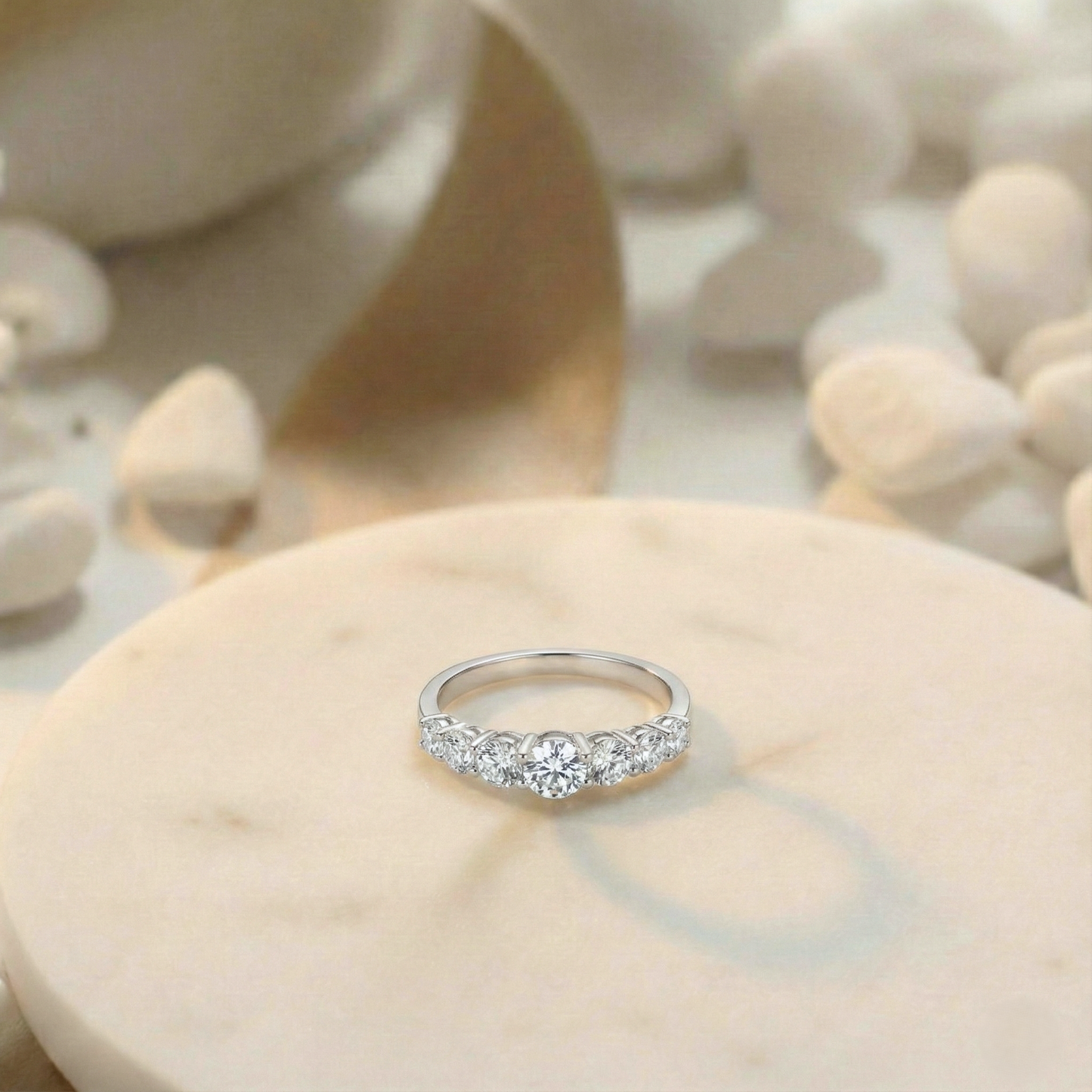 Silver ring with diamonds on a shell