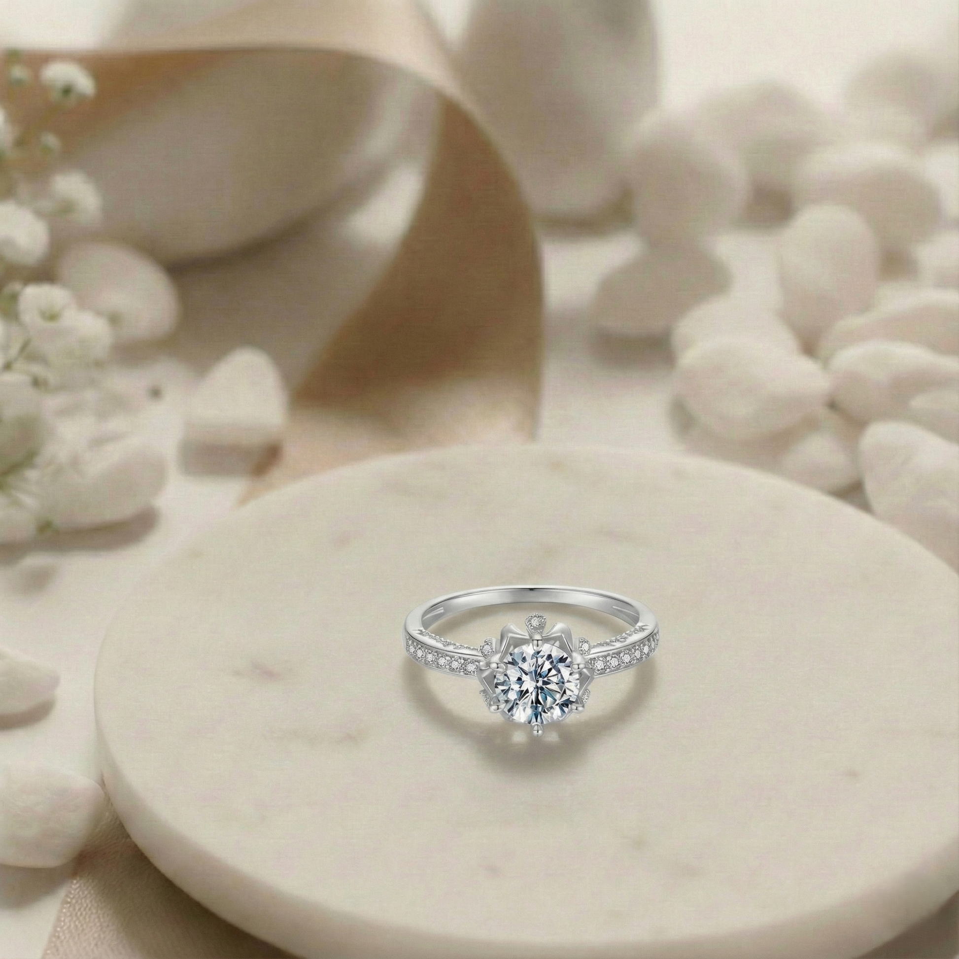 Silver ring with a diamond on a stone surface with flowers and stones in the background