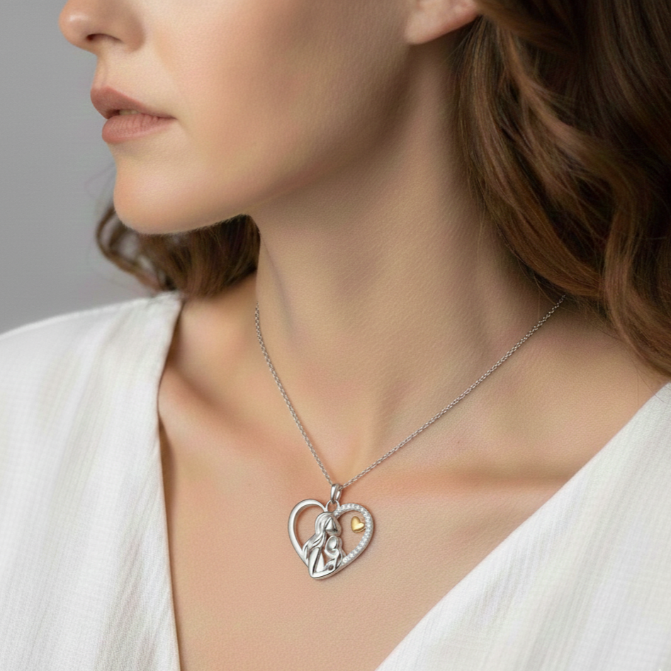 Silver mother and child heart necklace worn to show pendant length and shine.