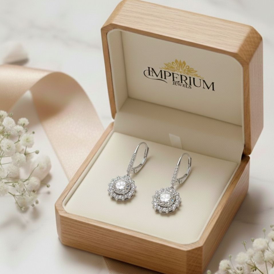 Diamond earrings in a 'Imperium Jewels' box with white flowers on a light background