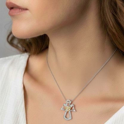Silver necklace with a heart pendant worn by a person